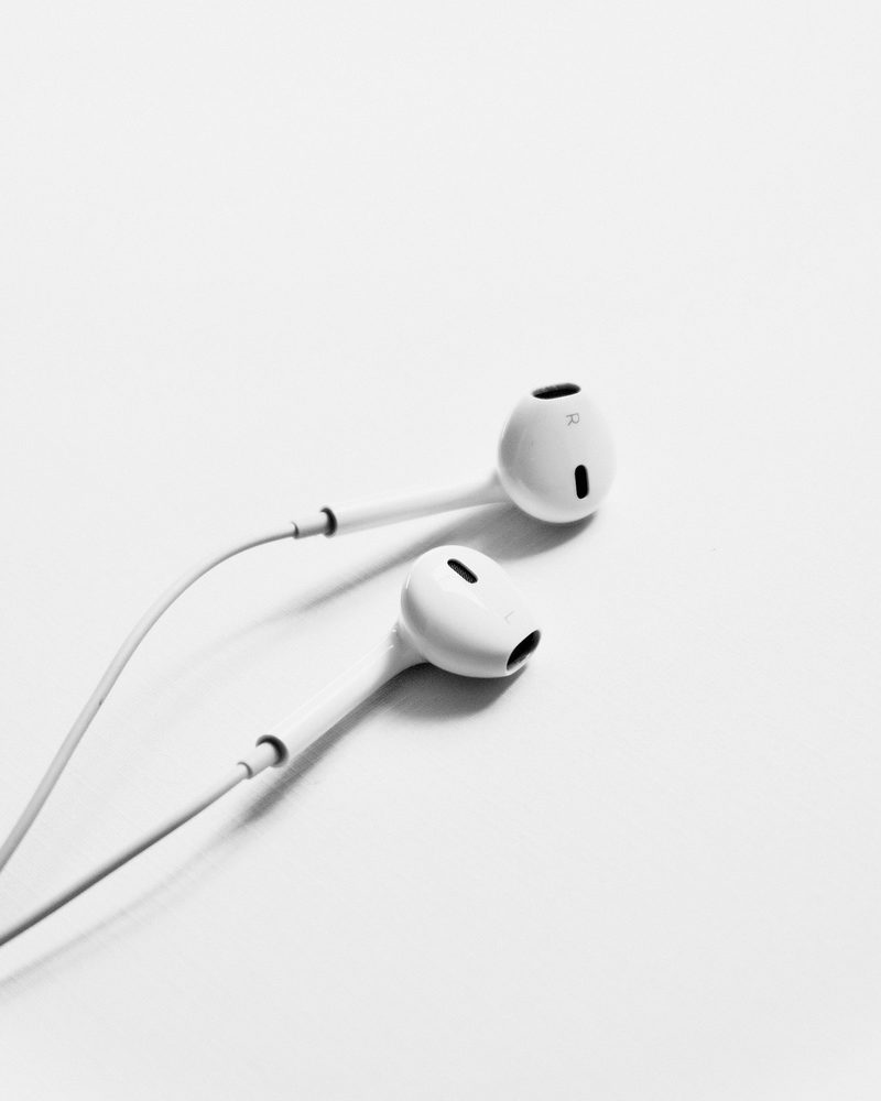 White wired earphones on a white ground