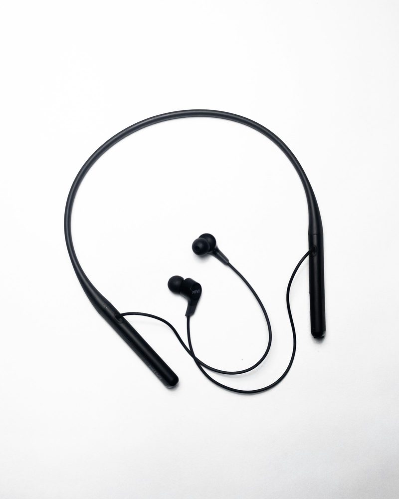 Bluetooth neckband earphones on a white ground